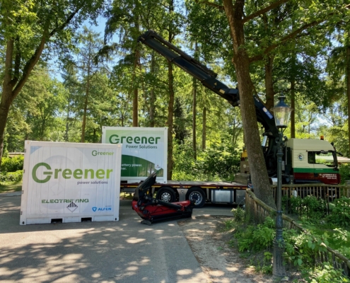 Two of our Greener batteries with the old and new branding in the forest